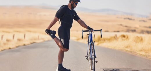Radfahrer Training - Fahrradfahrer dehnt sich an seinem Fahrrad